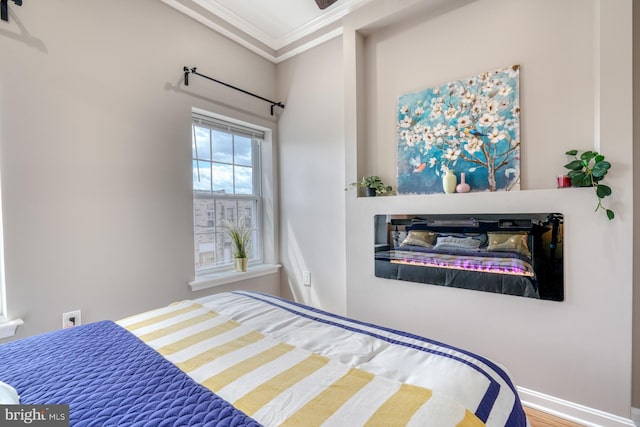 bedroom with crown molding and wood-type flooring