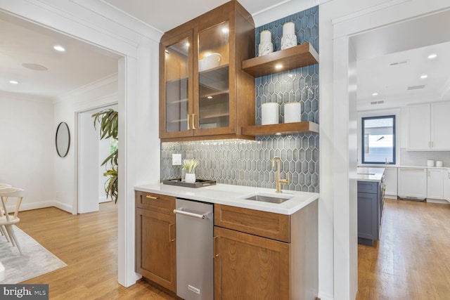 6019 Utah Ave NW, Washington, DC 20015 - bar area with a sink, crown molding, light wood-style floors, tasteful backsplash, and dishwasher