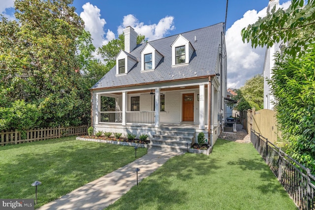 6019 Utah Ave NW, Washington, DC 20015 - new england style home featuring a high end roof, a chimney, brick siding, and covered porch