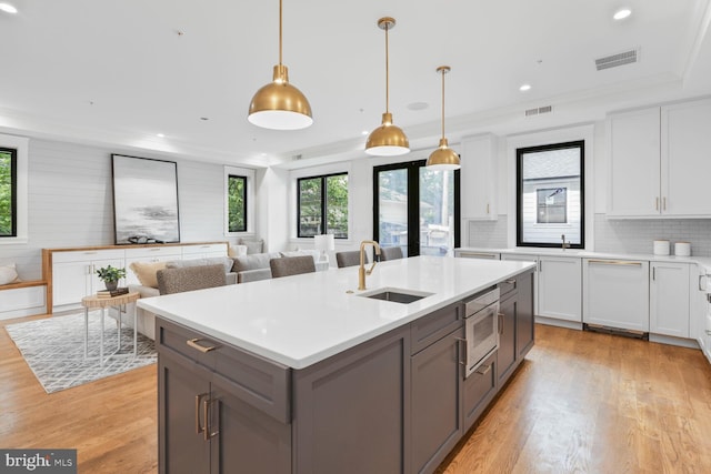 6019 Utah Ave NW, Washington, DC 20015 - kitchen featuring a sink, stainless steel microwave, light wood finished floors, light countertops, and recessed lighting