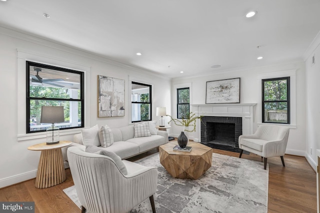 6019 Utah Ave NW, Washington, DC 20015 - living room featuring crown molding, a brick fireplace, baseboards, wood finished floors, and recessed lighting