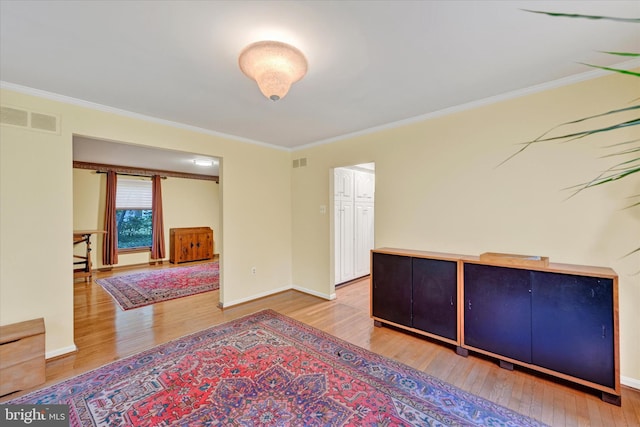 empty room with hardwood / wood-style flooring and ornamental molding