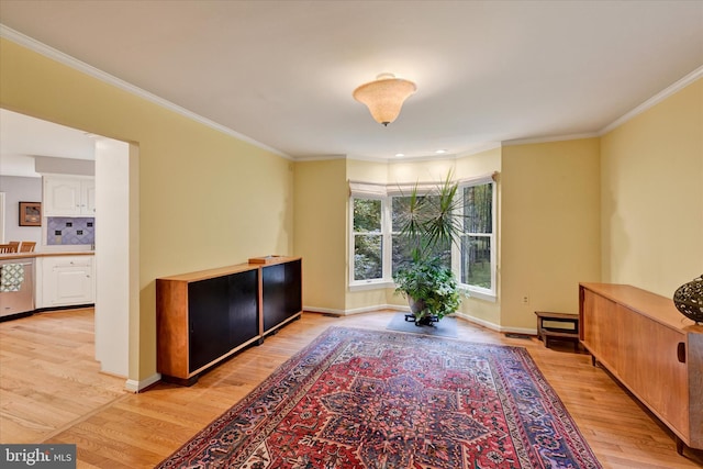 sitting room featuring ornamental molding and light hardwood / wood-style flooring