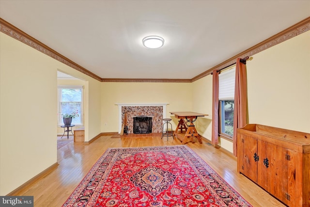 living room with ornamental molding and light hardwood / wood-style flooring