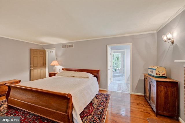 bedroom with light hardwood / wood-style flooring and ornamental molding