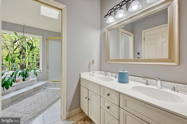 bathroom featuring vanity, a shower with shower door, and tile patterned flooring