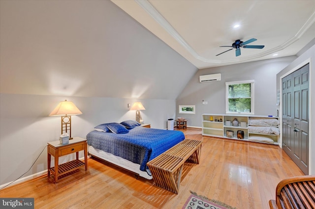 bedroom featuring a wall unit AC, ceiling fan, a closet, wood-type flooring, and crown molding