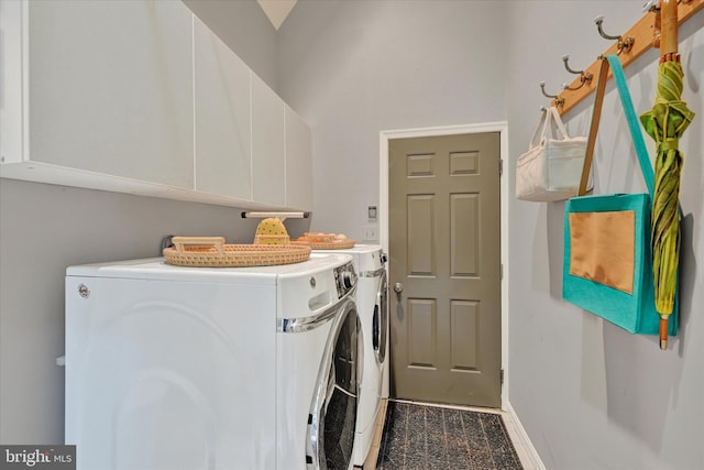 laundry room with washing machine and clothes dryer and cabinets