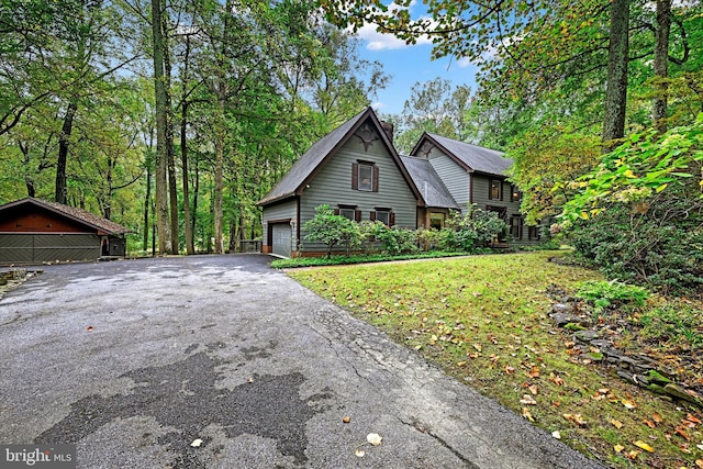 front of property with a front yard and a garage