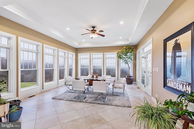 sunroom / solarium with a tray ceiling, ceiling fan, plenty of natural light, and french doors