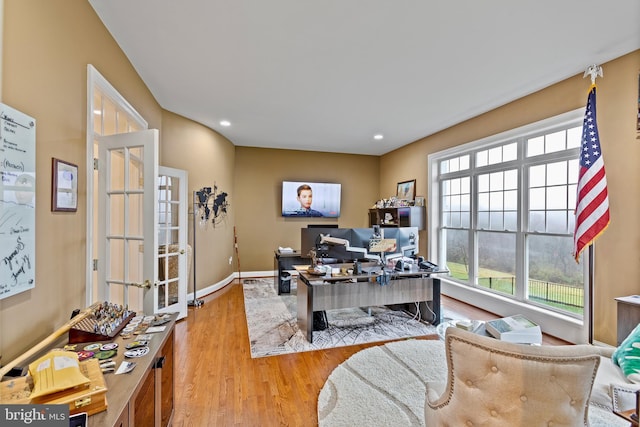 office featuring french doors and light hardwood / wood-style flooring