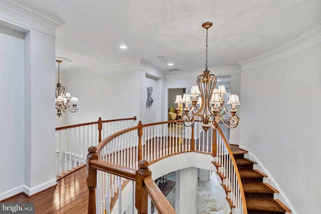 stairway featuring a chandelier, wood-type flooring, and crown molding