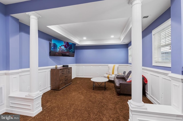 sitting room featuring dark colored carpet, ornamental molding, and a tray ceiling