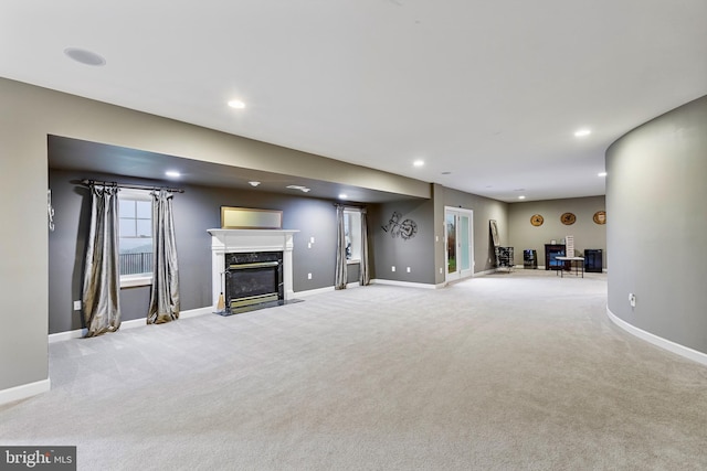 unfurnished living room with a fireplace and light carpet