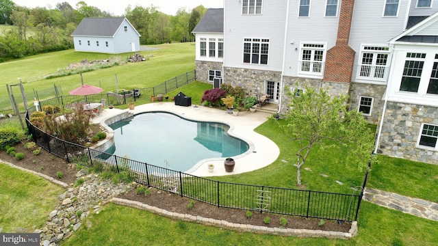 view of swimming pool featuring a lawn and a patio area