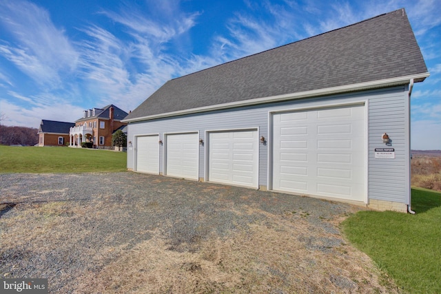 garage featuring a lawn