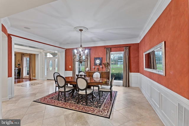 tiled dining space with a notable chandelier and crown molding