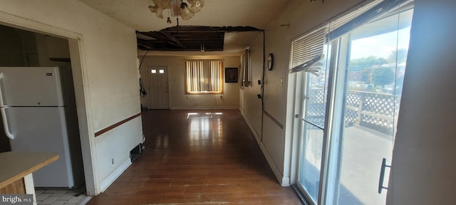 hallway featuring dark hardwood / wood-style floors and a textured ceiling