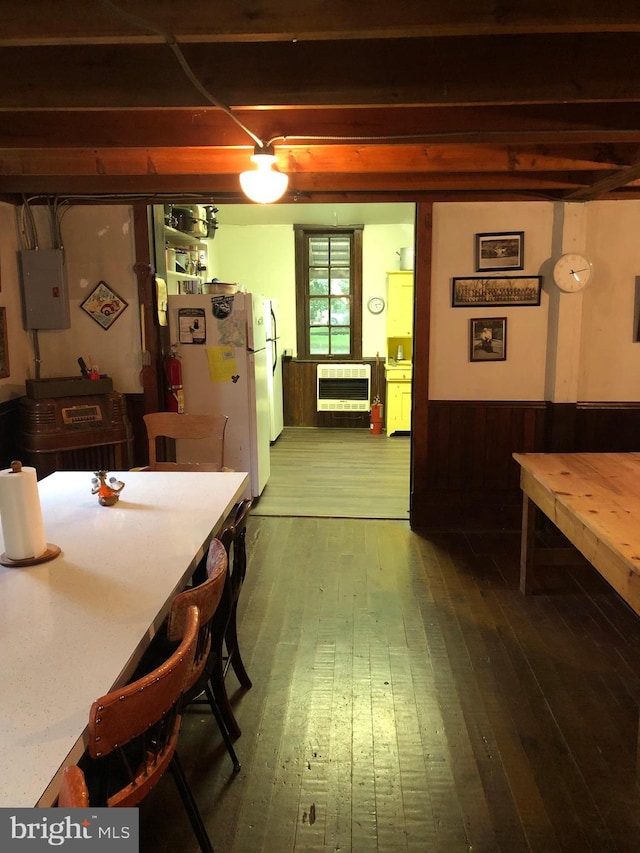 174 Jamison City Rd, Benton, PA 17814 - dining room featuring heating unit, wooden walls, electric panel, and wood-type flooring