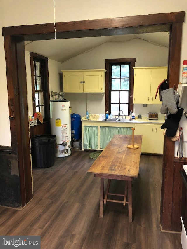 174 Jamison City Rd, Benton, PA 17814 - kitchen with lofted ceiling, white cabinets, gas water heater, sink, and dark hardwood / wood-style flooring