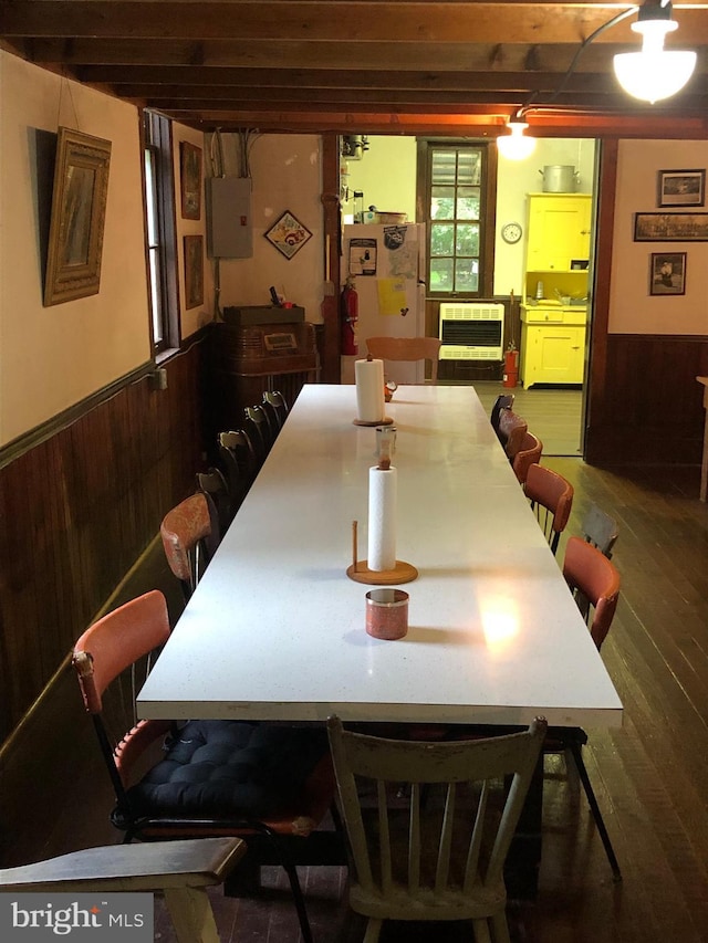 174 Jamison City Rd, Benton, PA 17814 - dining space with heating unit, wooden walls, and hardwood / wood-style floors