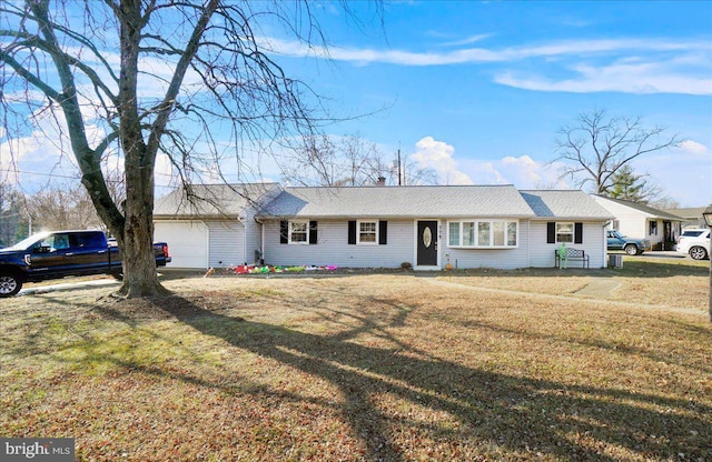 ranch-style house with a garage and a front yard