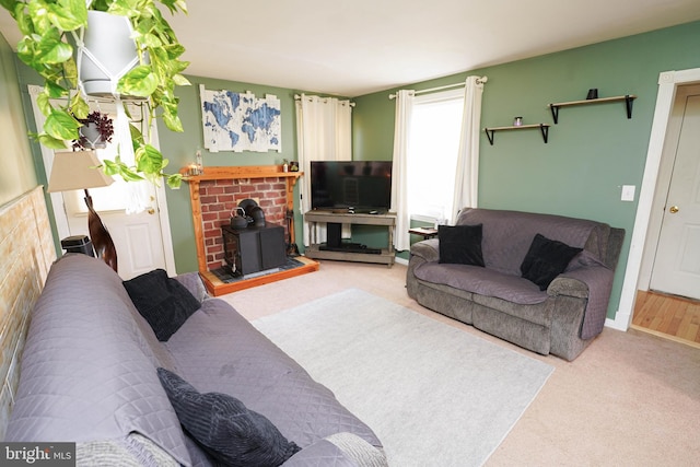 carpeted living room featuring a wood stove