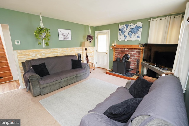 living room with carpet flooring and a wood stove