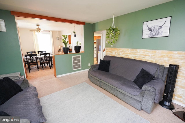 living room with carpet and ceiling fan