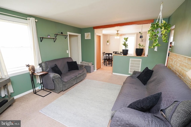 living room with ceiling fan and light colored carpet