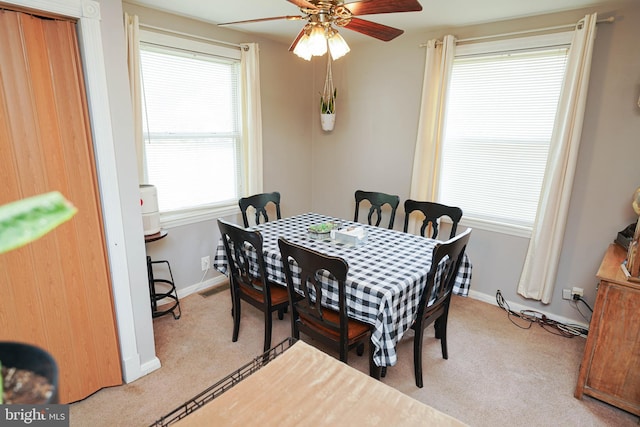 carpeted dining area featuring ceiling fan