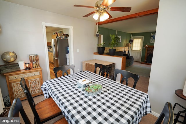 carpeted dining area featuring ceiling fan