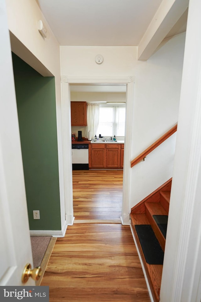 hallway featuring sink and light wood-type flooring