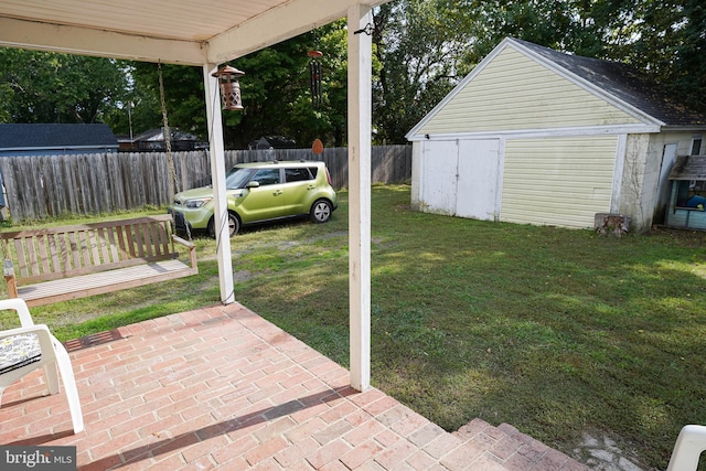 view of yard featuring a storage shed, a patio area, and a carport