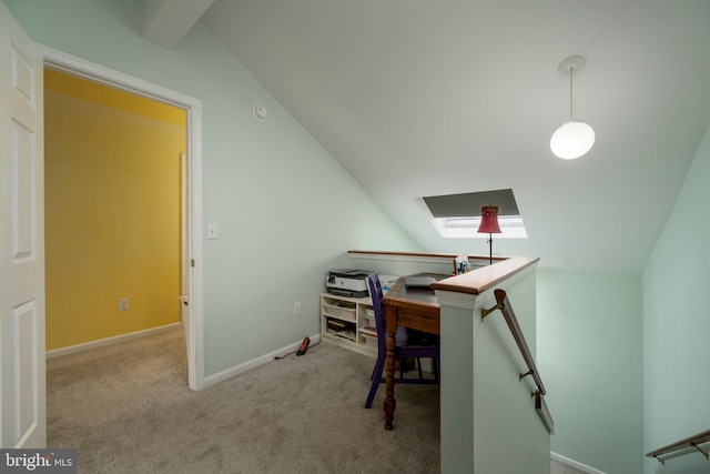 carpeted home office featuring lofted ceiling with skylight