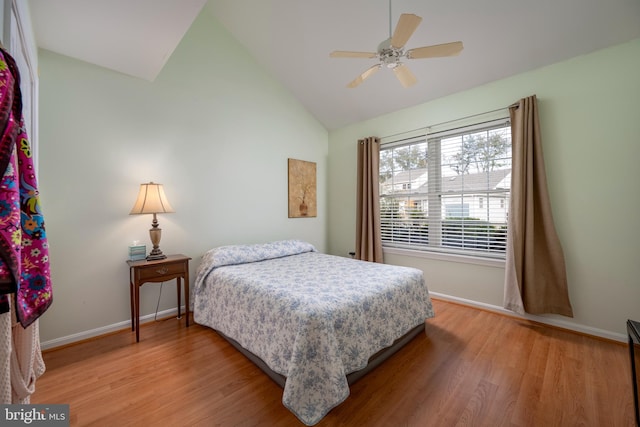 bedroom featuring high vaulted ceiling, ceiling fan, and light hardwood / wood-style flooring