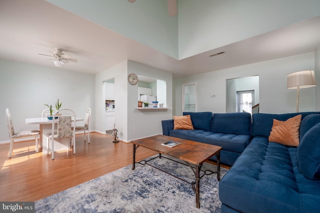 living room with hardwood / wood-style flooring and ceiling fan