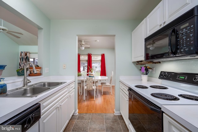 kitchen featuring dishwasher, white electric range oven, sink, and white cabinetry