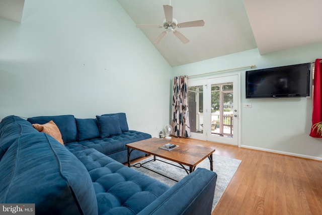 living room with ceiling fan, light hardwood / wood-style floors, and high vaulted ceiling