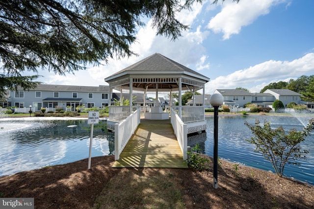 view of dock featuring a gazebo and a water view