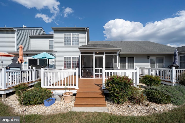 back of house with a deck and a sunroom