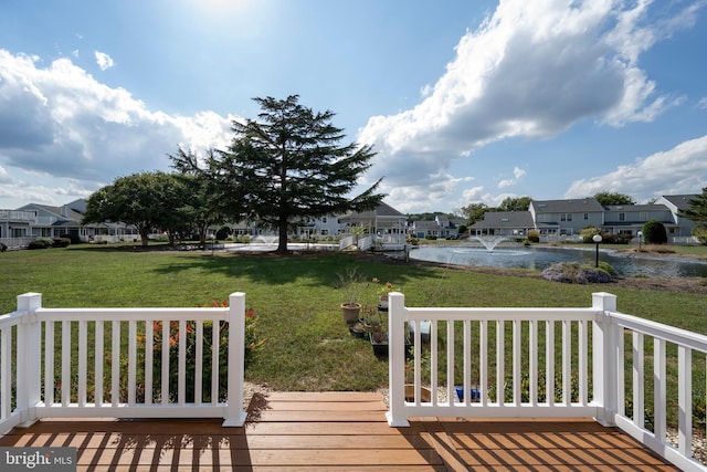 deck featuring a water view and a yard