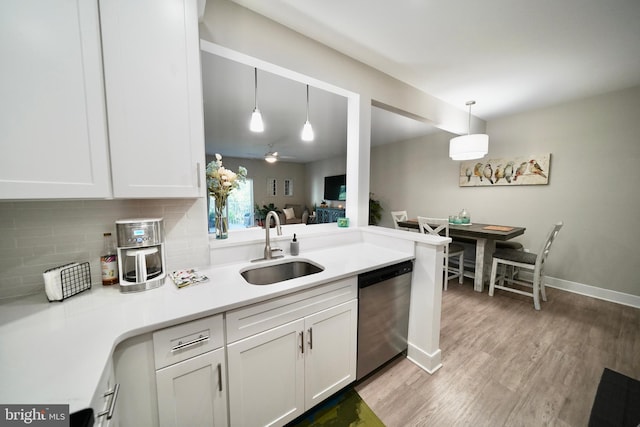 kitchen with white cabinetry, stainless steel dishwasher, light hardwood / wood-style floors, and sink