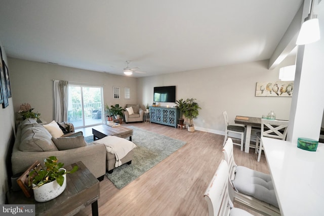 living room featuring hardwood / wood-style floors and ceiling fan