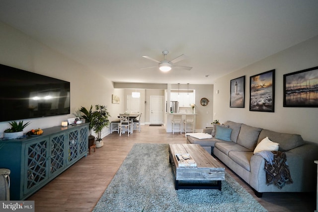 living room with hardwood / wood-style flooring and ceiling fan