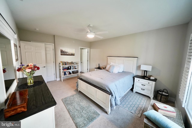 carpeted bedroom featuring a closet and ceiling fan