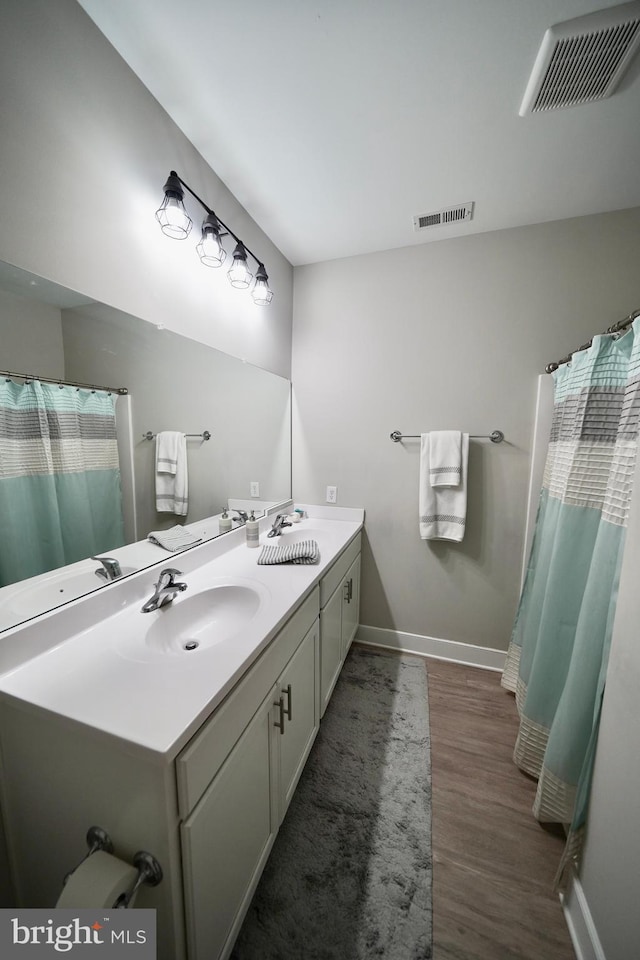 bathroom with vanity and wood-type flooring