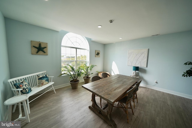 dining space with dark wood-type flooring