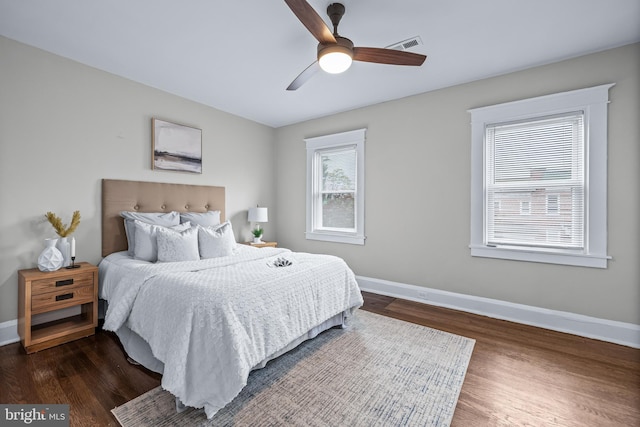 bedroom with dark wood-type flooring and ceiling fan