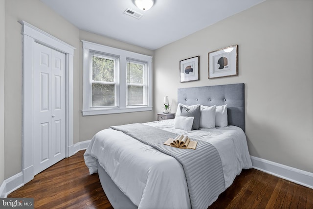 bedroom featuring a closet and dark wood-type flooring